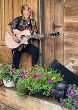 Musician on stage with flowers